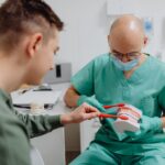 Family dentist advising a patient on how to choose a dentist