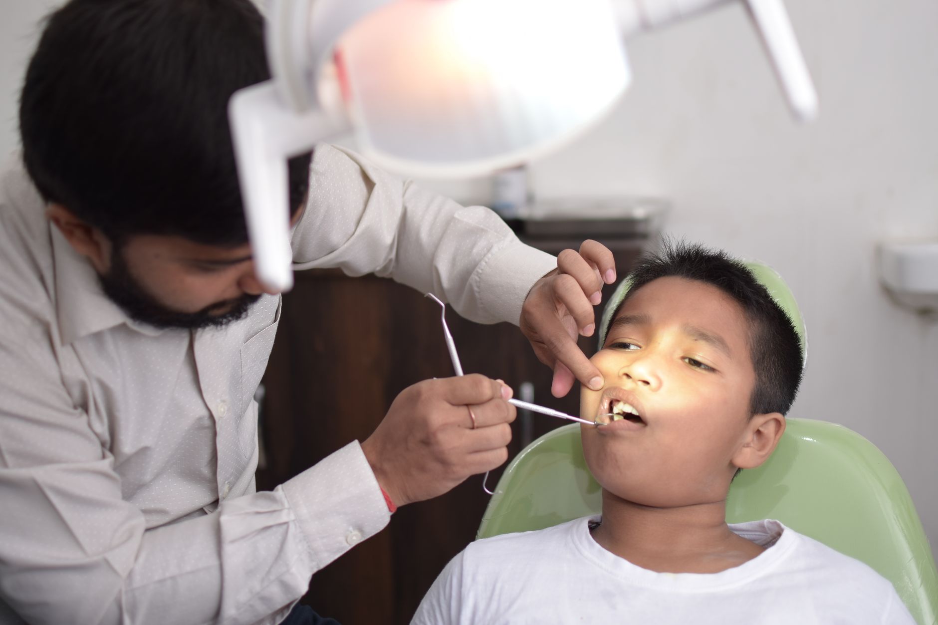 Dentist explaining tooth extraction vs root canal options to a patient