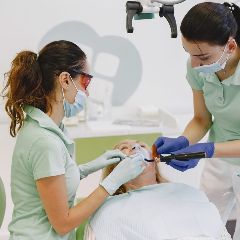 Dentist explaining composite vs amalgam fillings to a patient