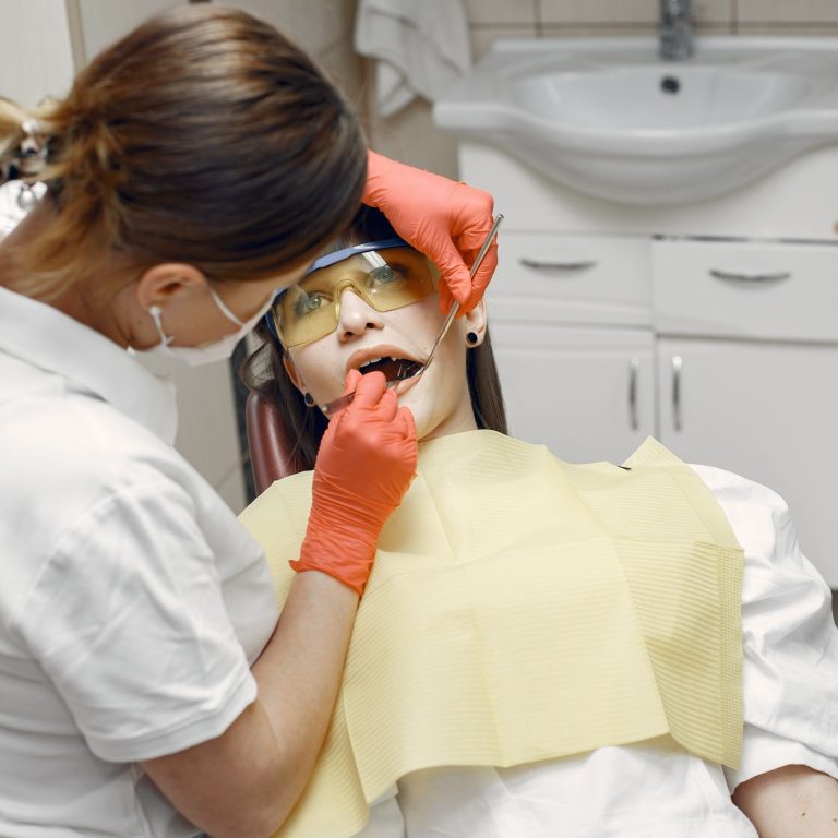 Dental patient relaxed in chair discussing sedation dentistry options with dentist
