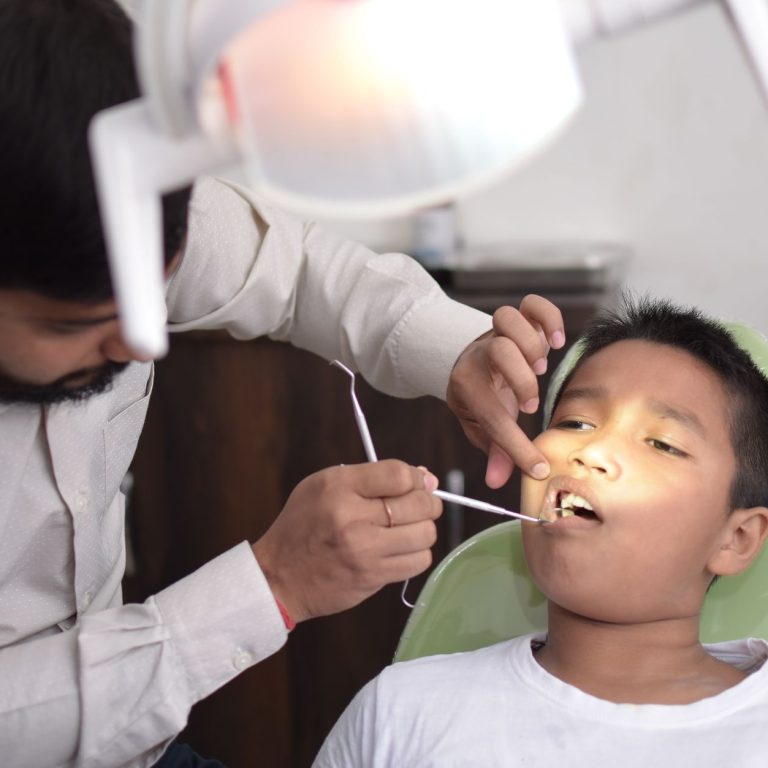 Dentist explaining tooth extraction vs root canal options to a patient